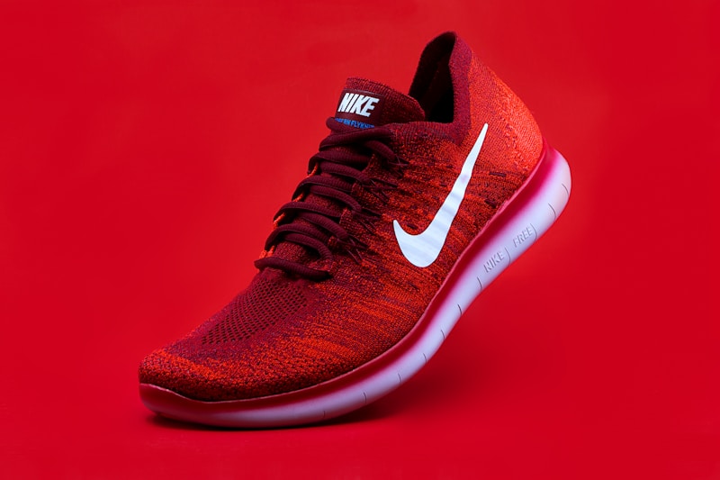 Red knit running shoe against a red backdrop in a mock Meta ad